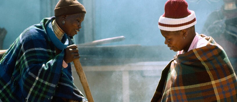 These women -- members of the Ndebele tribe in South Africa -- are preparing food for a feast given to celebrate their sons' initiation ceremonies. 1984.